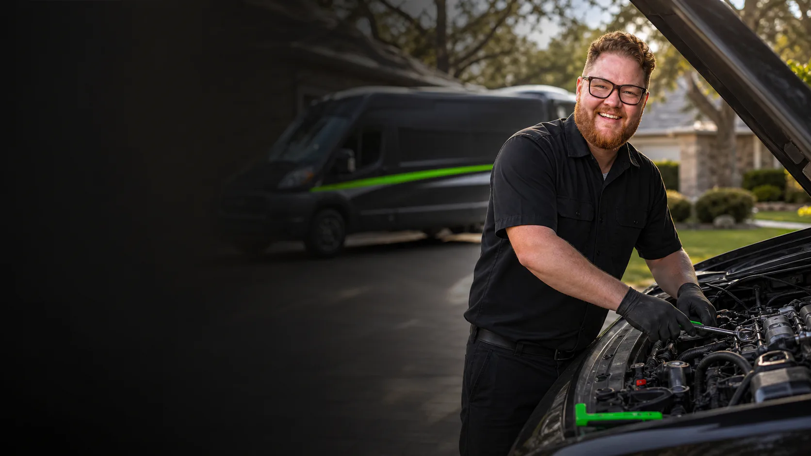 Garrett's Garage mobile mechanic working beside a branded service van