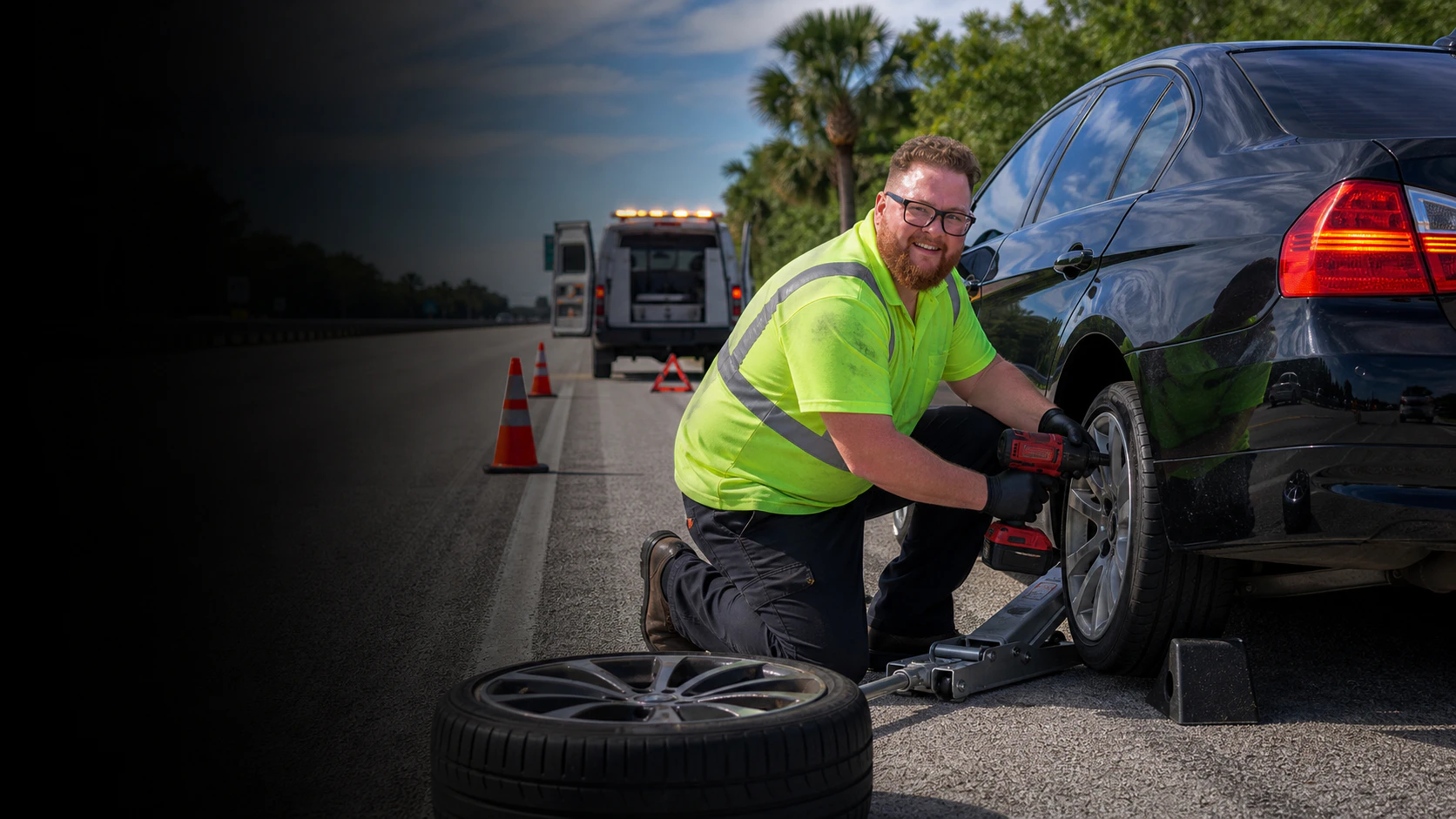 Garrett's Garage mechanic providing emergency roadside assistance beside a service van