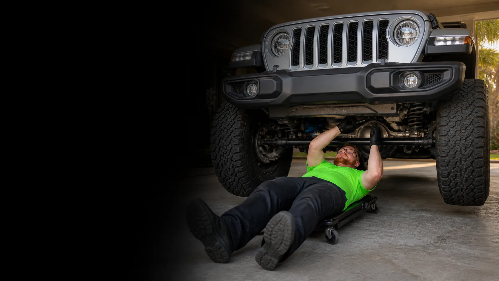 Mobile mechanic repairing a vehicle beside a service van in Orlando at night