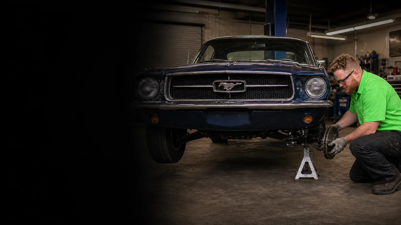 Garrett's Garage mechanic repairing a classic car's front suspension
